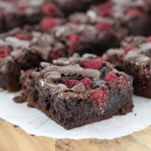 Pieces of fudgy chocolate brownie with raspberries throughout.