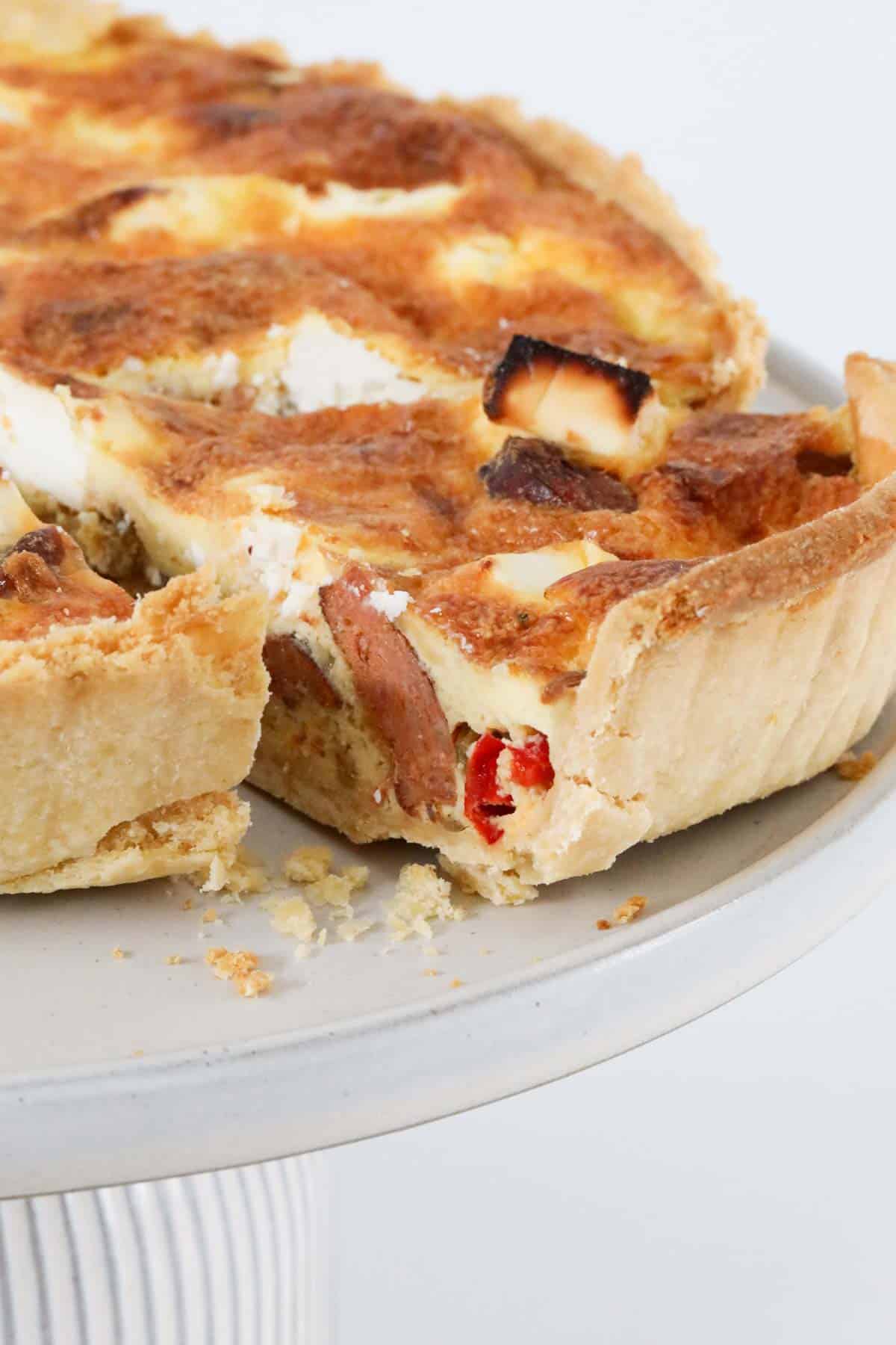 Baked chorizo quiche with a slice cut out to show the filling.