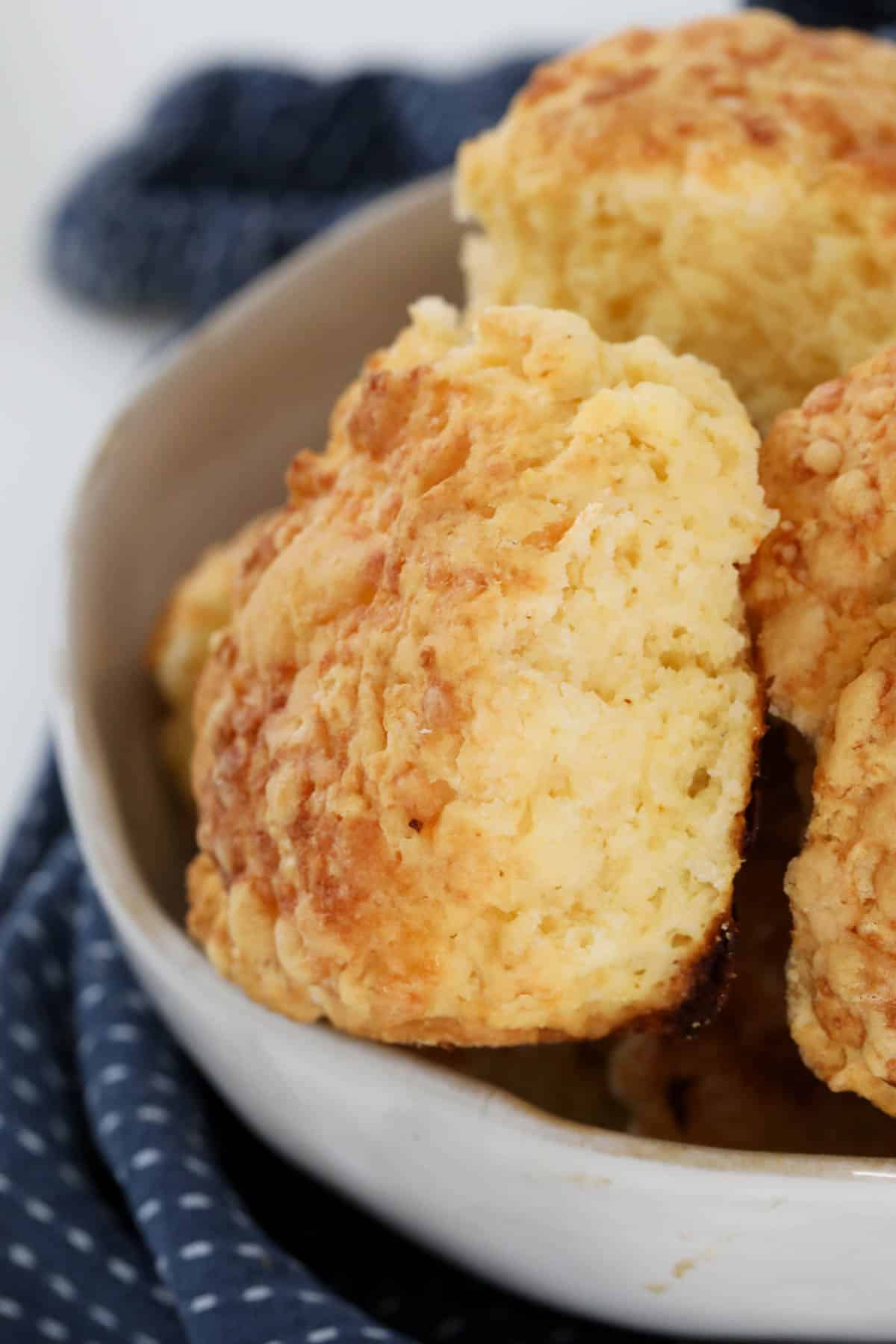 A close up of a bowl of gluten free cheese scones.