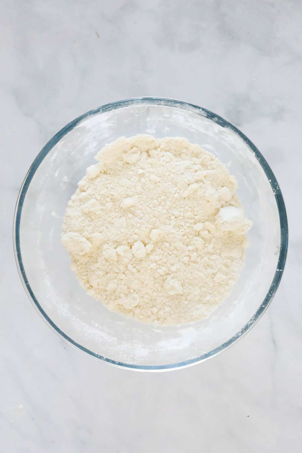 Flour and butter mixture resembling breadcrumbs in a bowl.