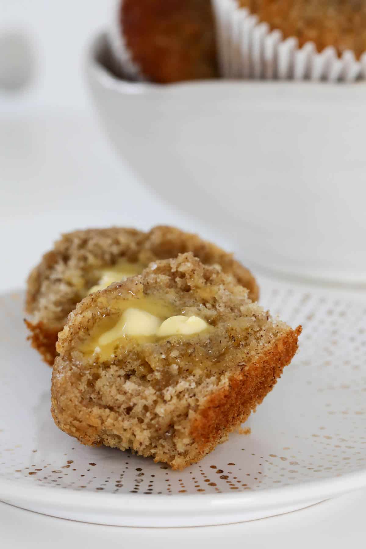 A banana muffin halved with butter.