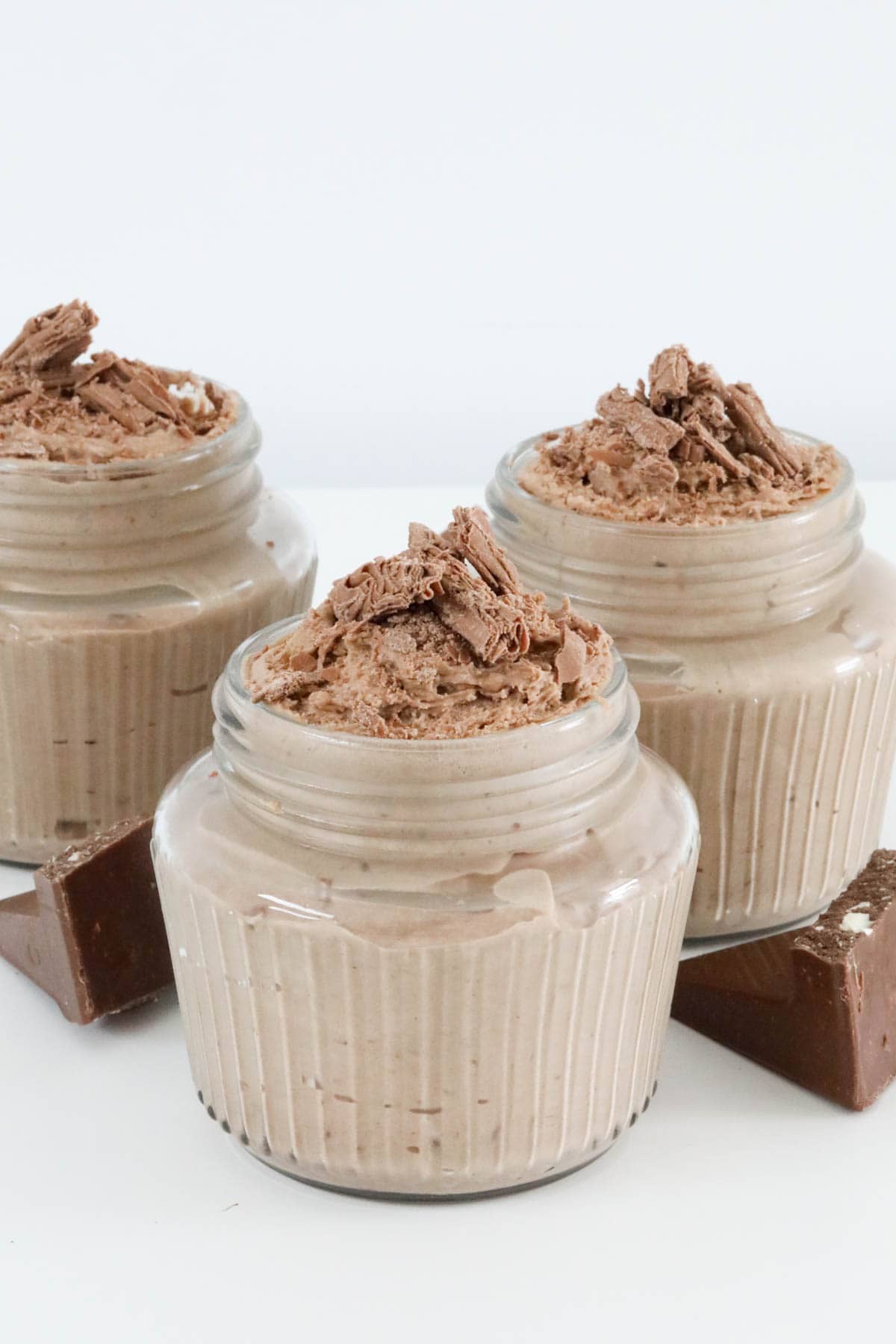 Three glass jars filled with Toblerone mousse and decorated with crumbled chocolate Flake.