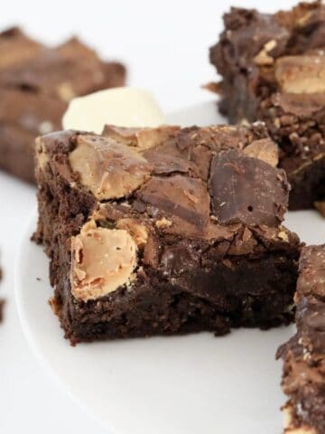 A piece of fudgy chocolate brownie with chunks of white and dark chocolate.