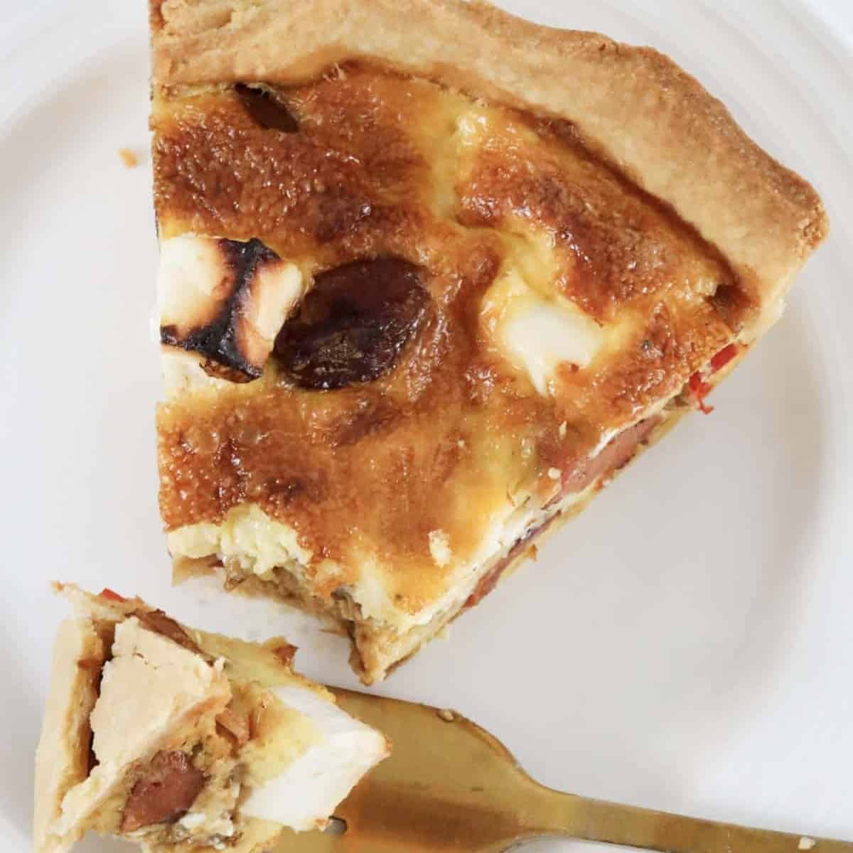 An overhead shot of a chorizo quiche with feta and capsium.
