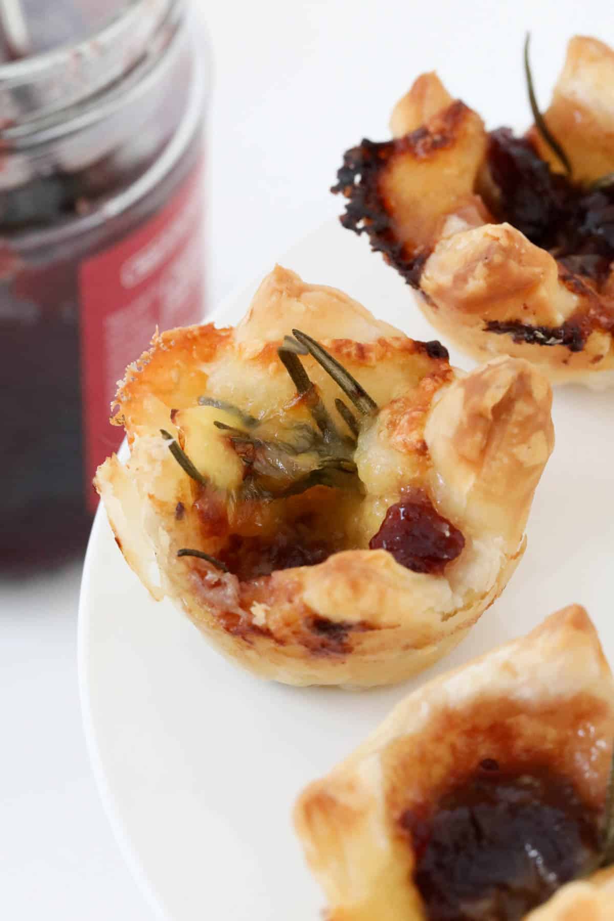 A close up of a golden cranberry brie pastry puff.