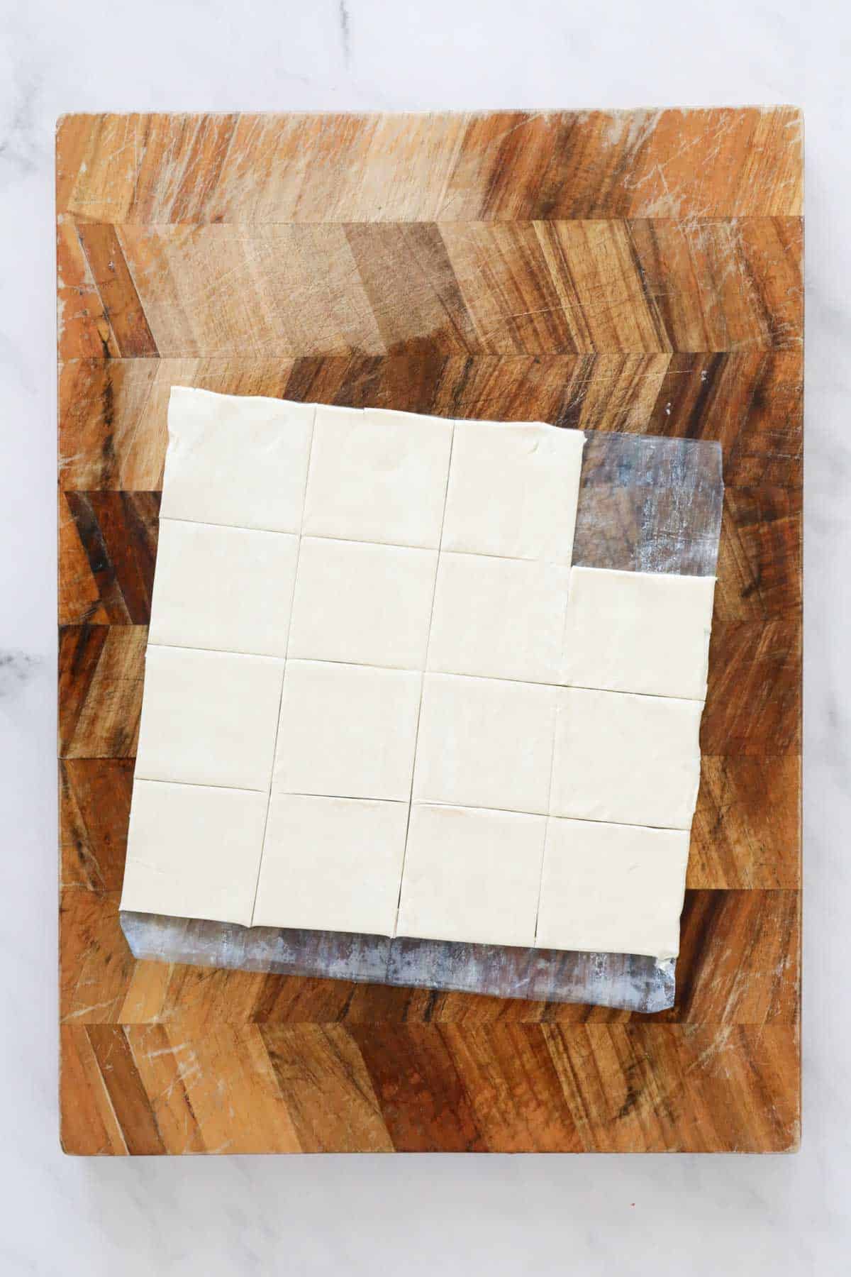 A puff pastry sheet cut into small squares