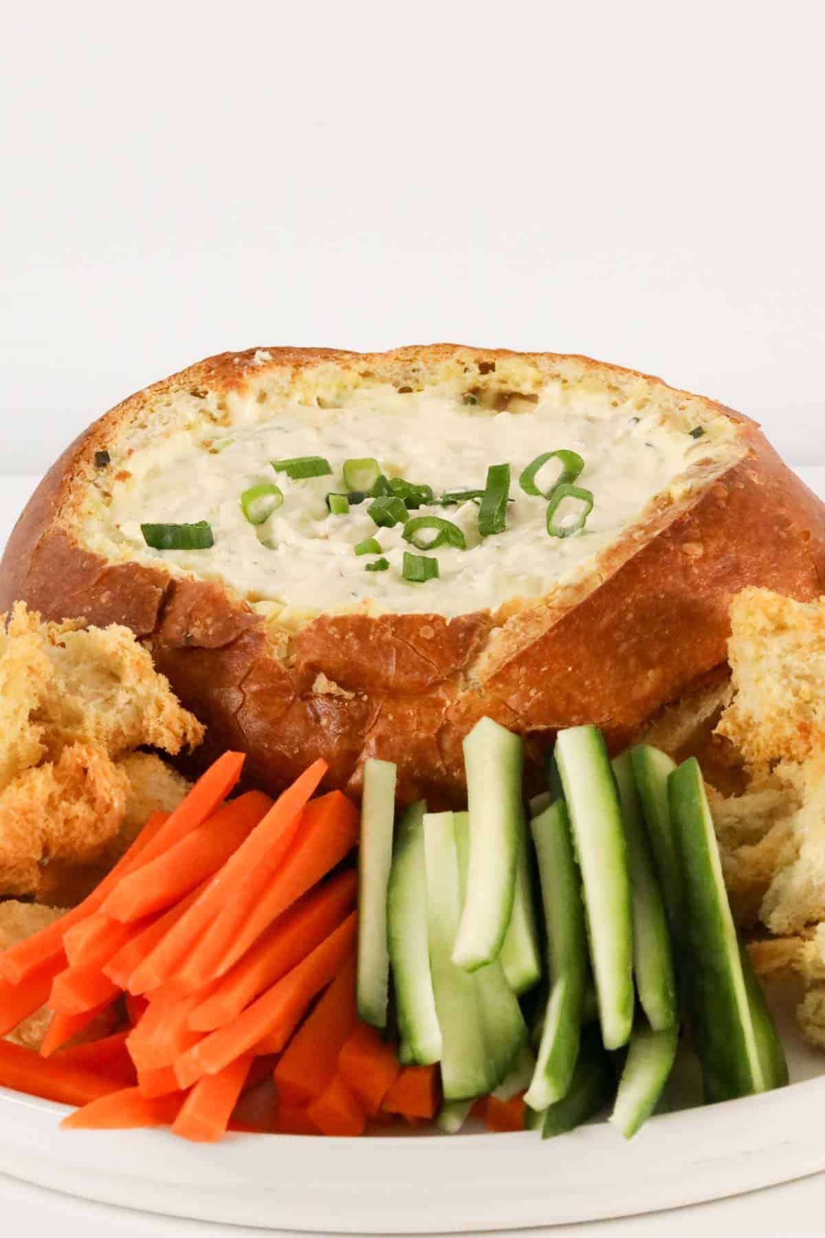 The cob loaf dip served with fresh carrot and cucumber sticks.