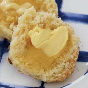 A gluten free cheese scone smothered with butter.