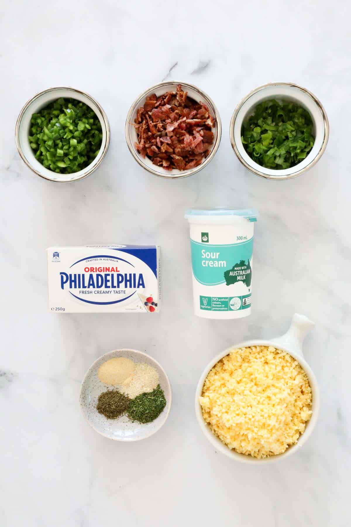 Jalapeno cheese ball ingredients measured and placed into individual bowls.