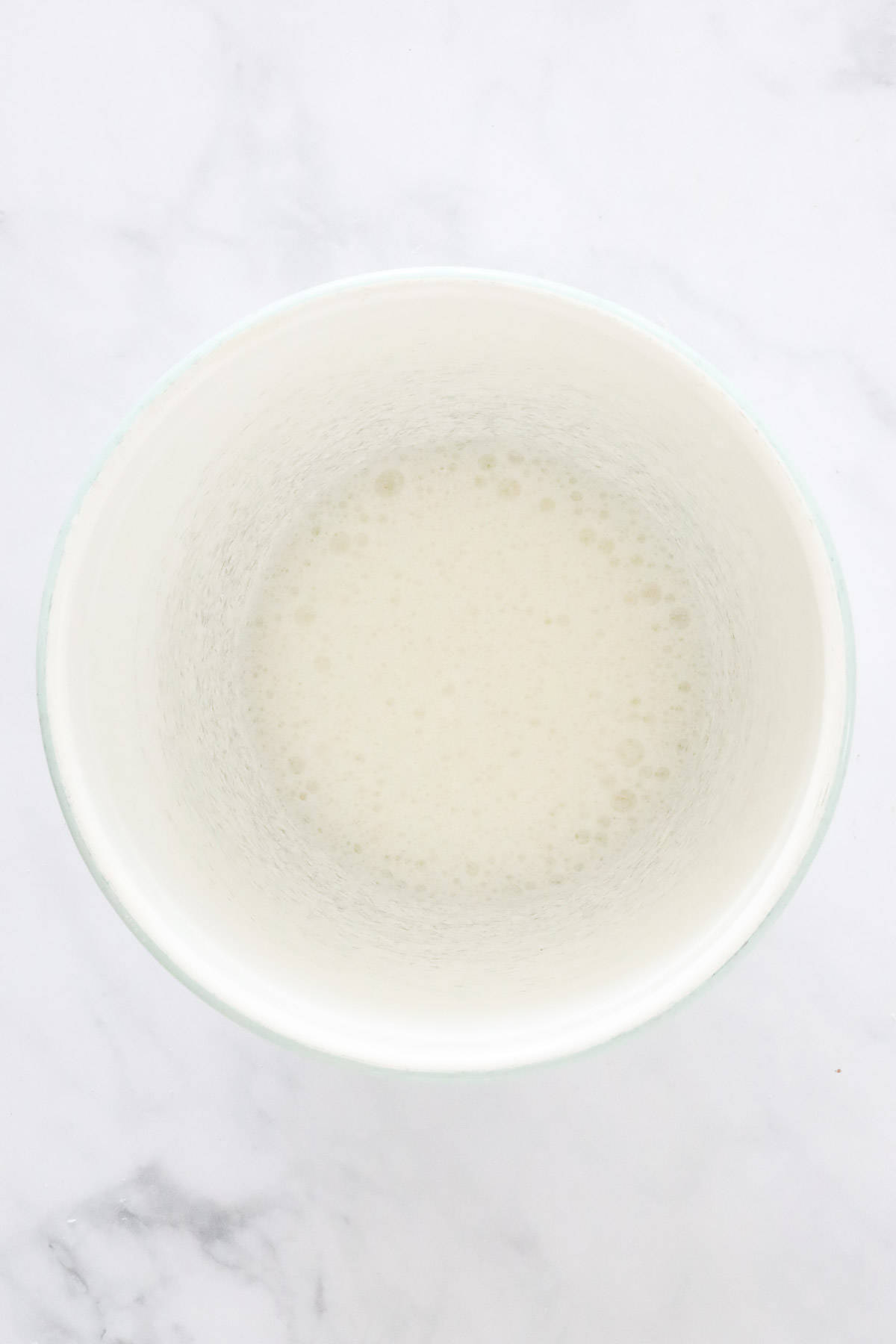 Egg whites that have been mixed until frothy in a bowl.