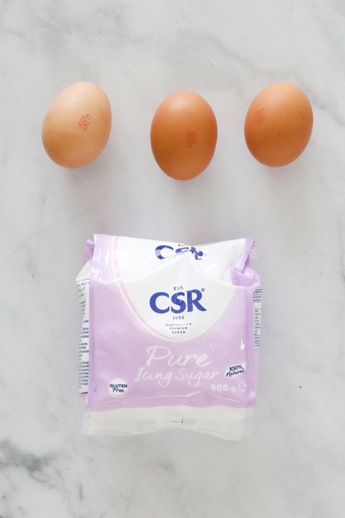 Eggs and pure icing sugar, the ingredients needed to make royal icing.