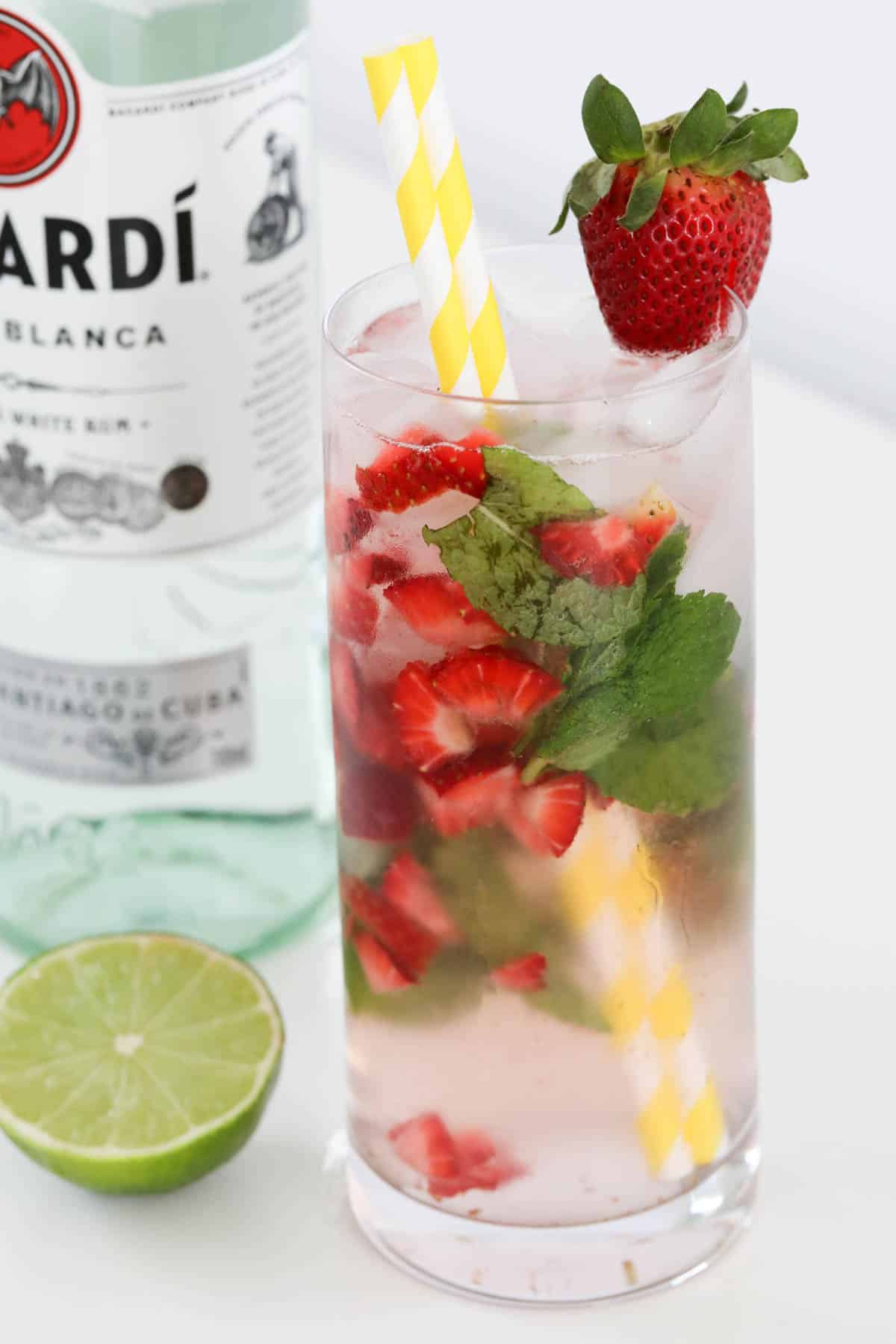 A bottle of Bacardi behind a tall glass of cocktail, ready to serve.