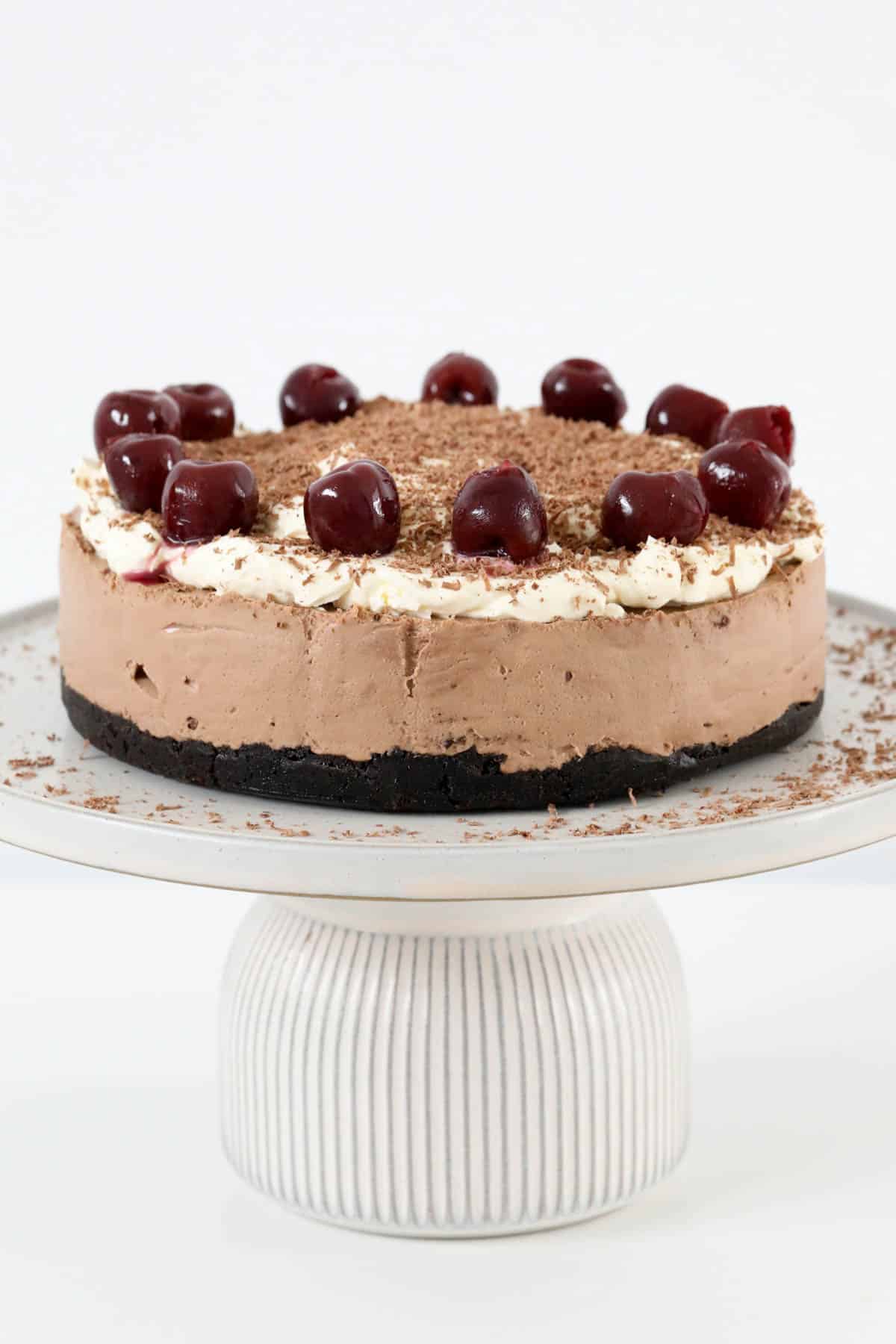 A Black Forest cheesecake on a cake stand.