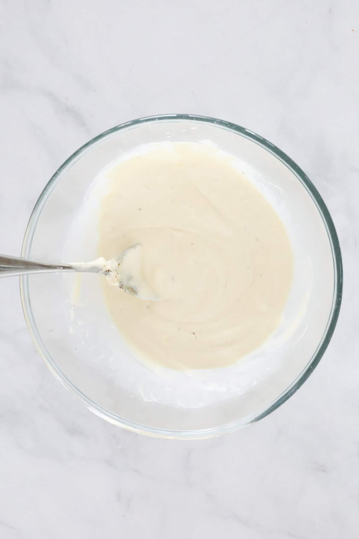 The mixed creamy mayo dressing in the mixing bowl.