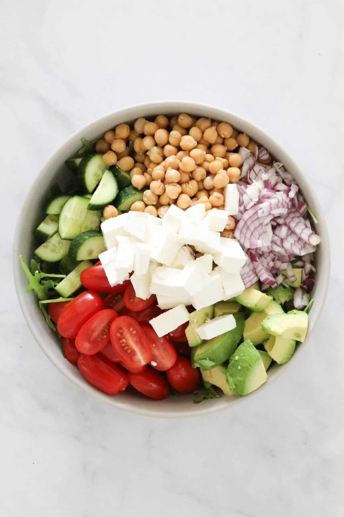 The chickpea salad ingredients placed in a mixing bowl.