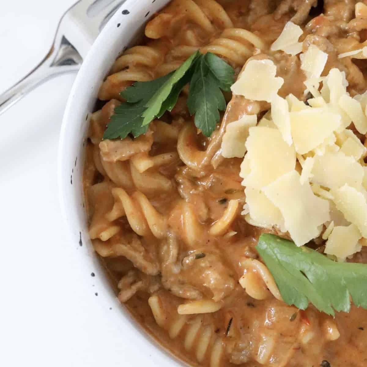 A bowl of creamy tomato pasta with beef mince.