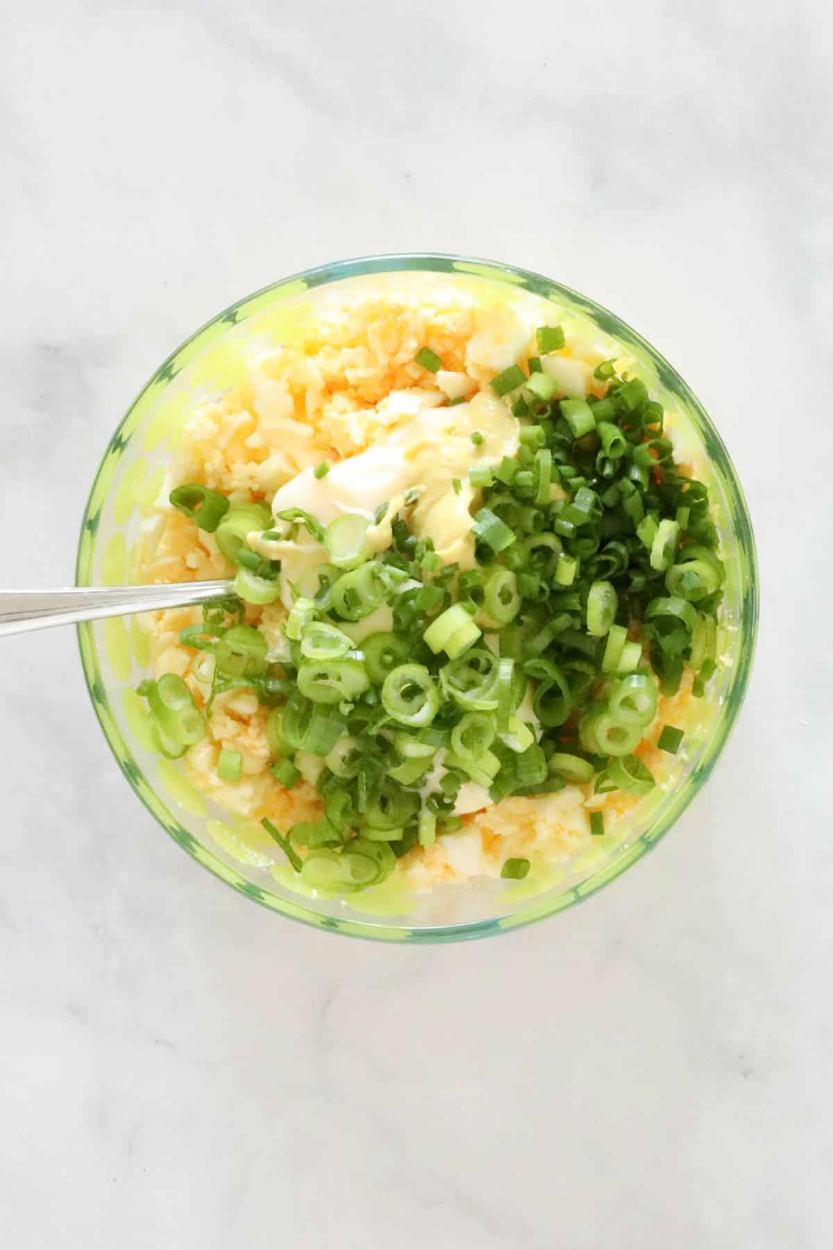 Mayonnaise, spring onions and Dijon mustard added to the mashed eggs.