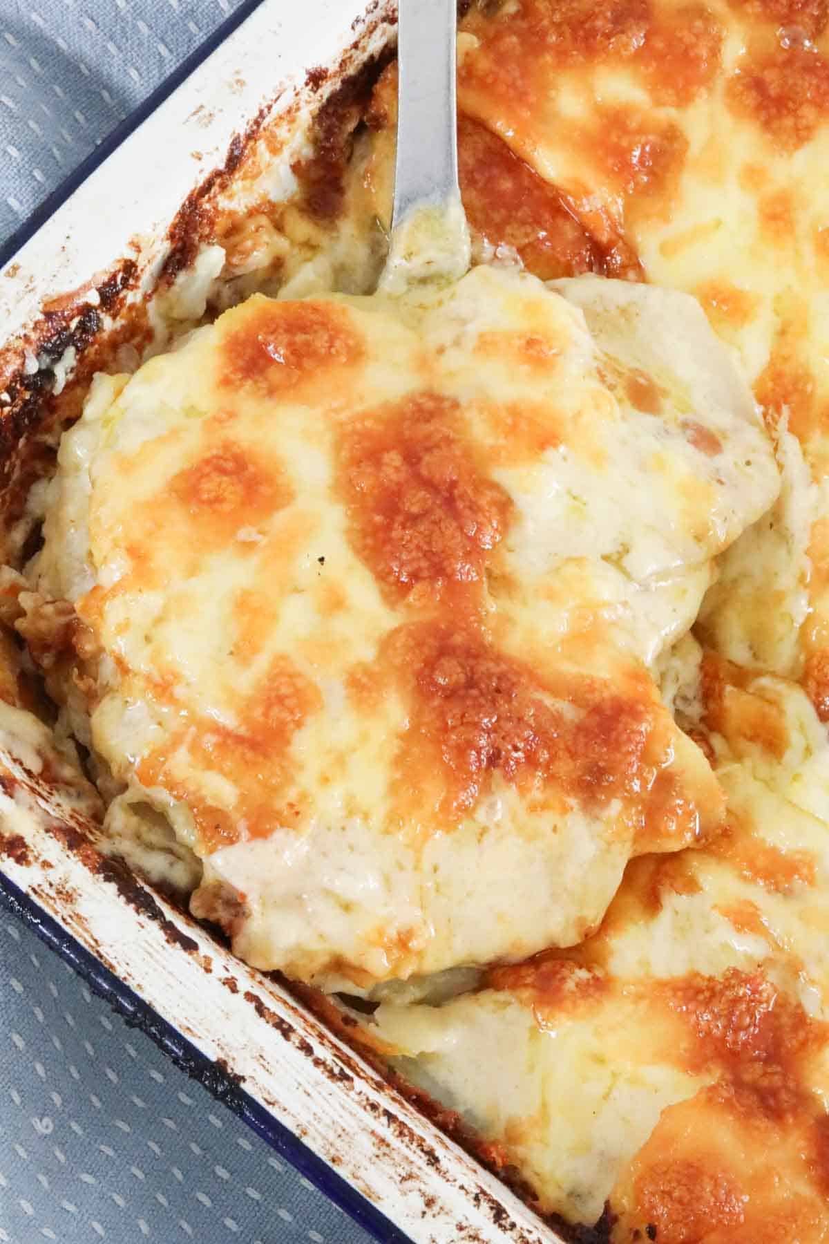 A close up of French onion potato bake in a baking dish.