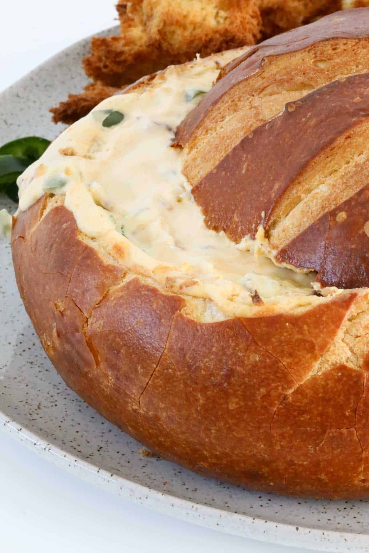 The baked cob loaf dip with the bread lid on top.