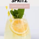 A limoncello spritz garnished with lemon slices and fresh mint.