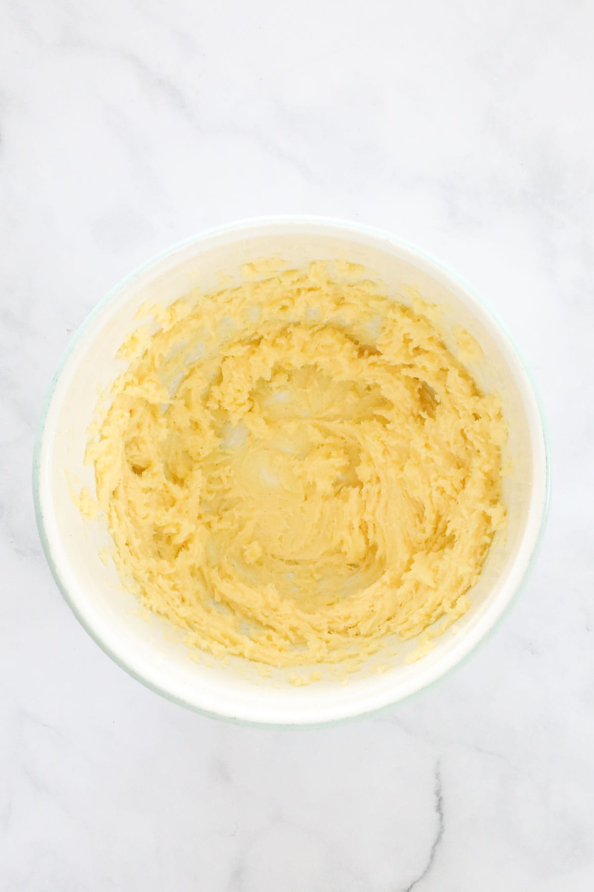 Creamed butter, sugar and vanilla bean paste in a mixing bowl.