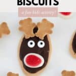 An arrowroot biscuit spread with melted chocolate and decorated with edible antlers, eyes and nose.