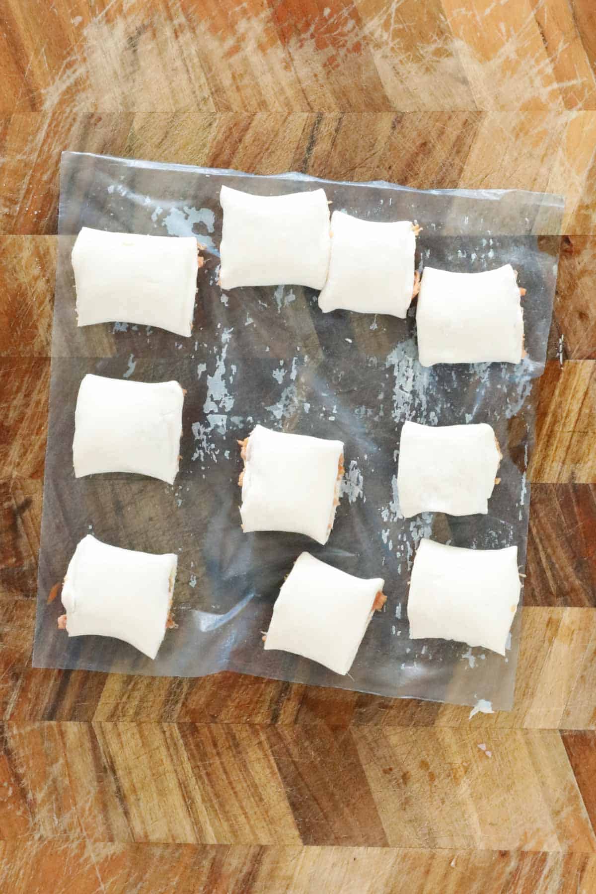 Uncooked sausage rolls cut into bite size pieces.