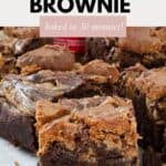 Squares of brownie with chunks of Biscoff biscuit baked on top.