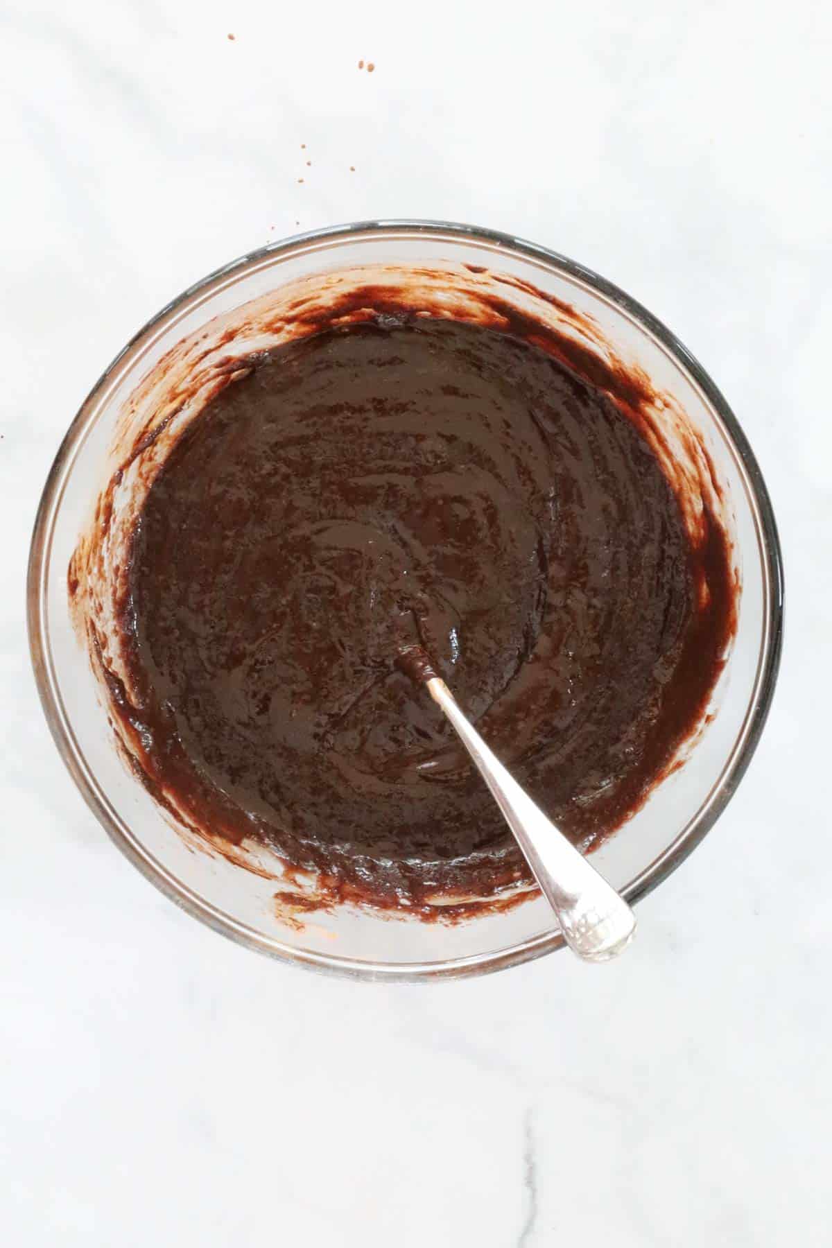 A glossy chocolate mixture after eggs and vanilla essence have been mixed through.