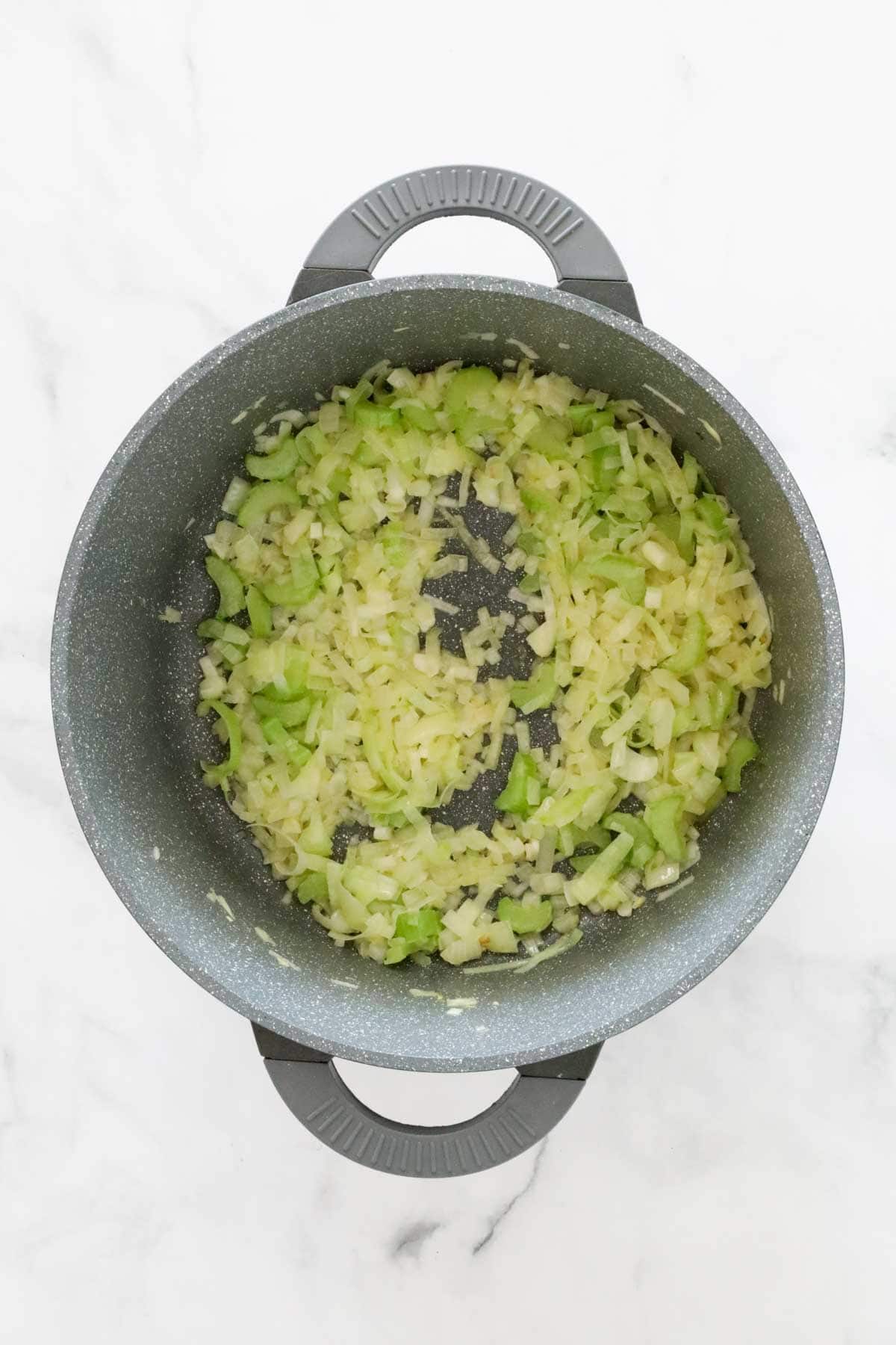 Onion, celery and leek being sauteed in the pot.
