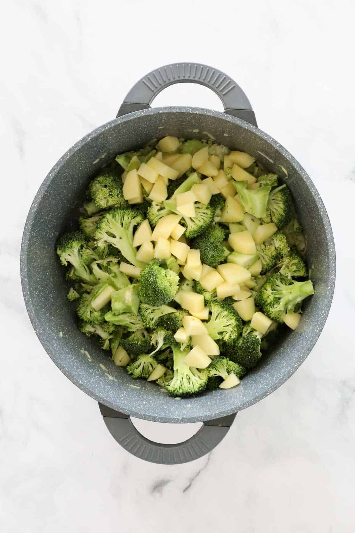Diced potato and broccoli florets added to the pot.
