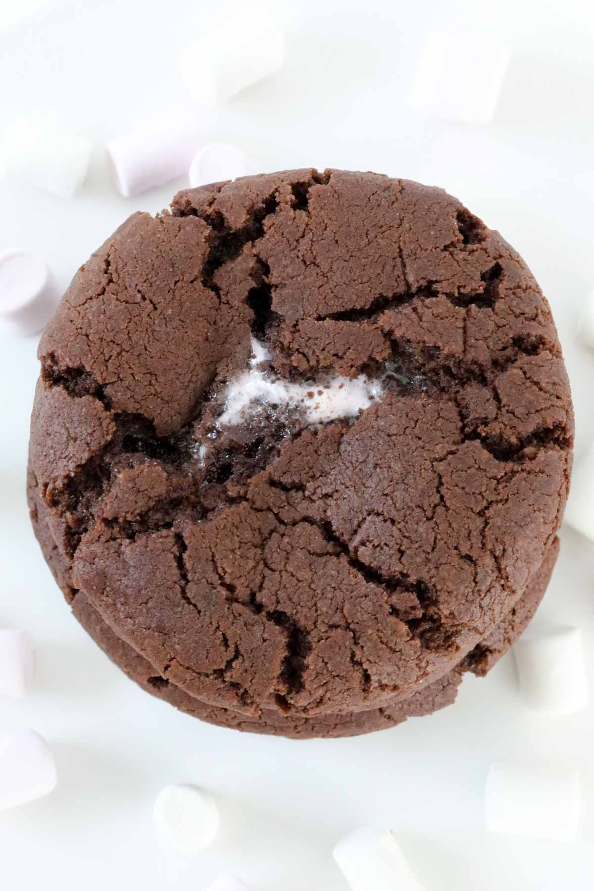 An overhead shot of a chocolate cookie with marshmallow inside.