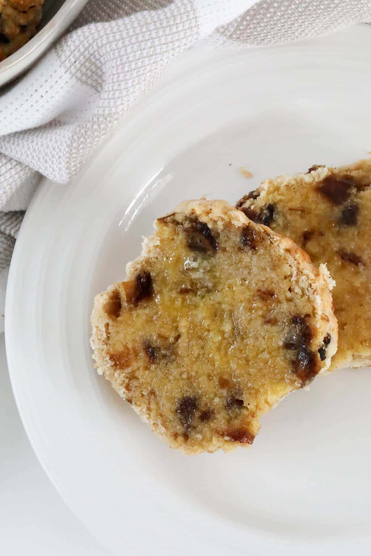 Overhead shot of a buttered date scone, cut in half.