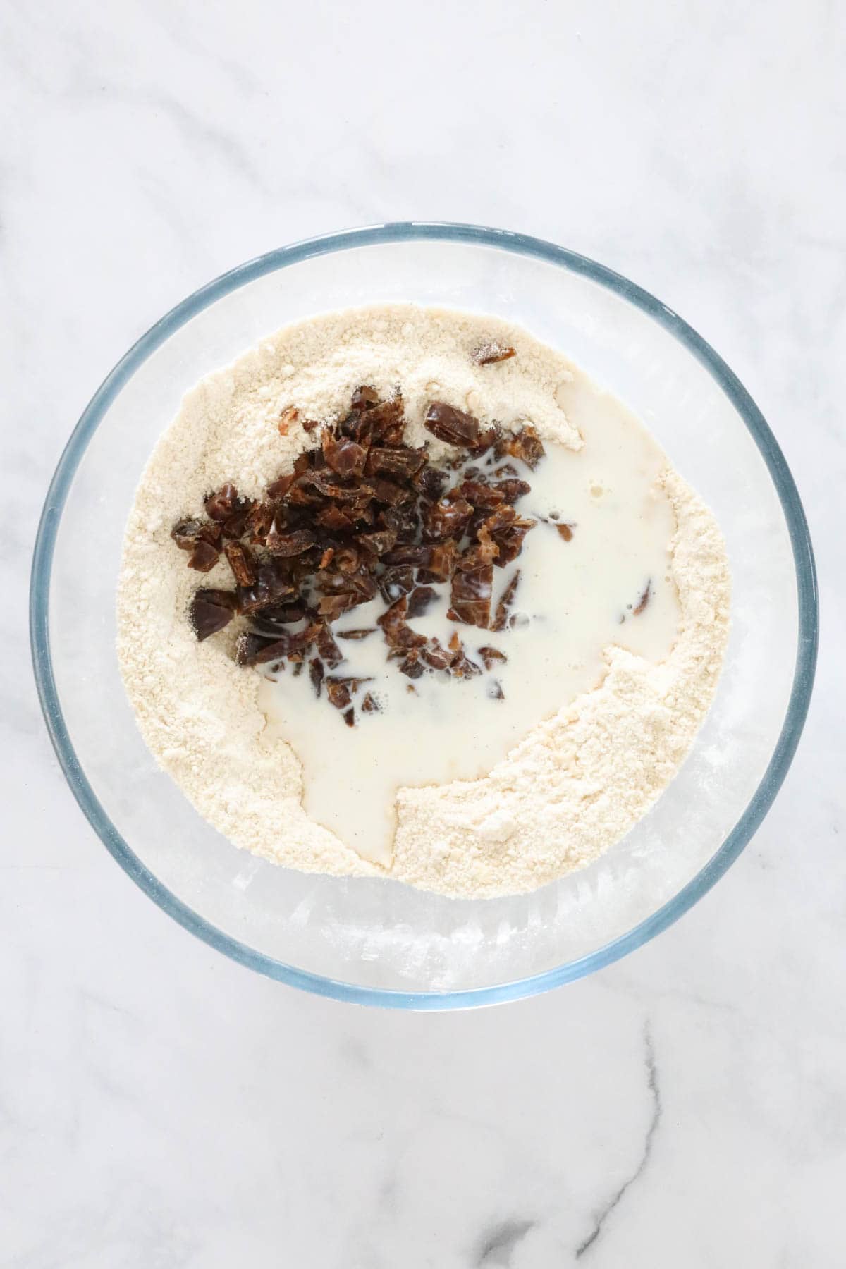 Milk added to the bowl with the flour and dates in.