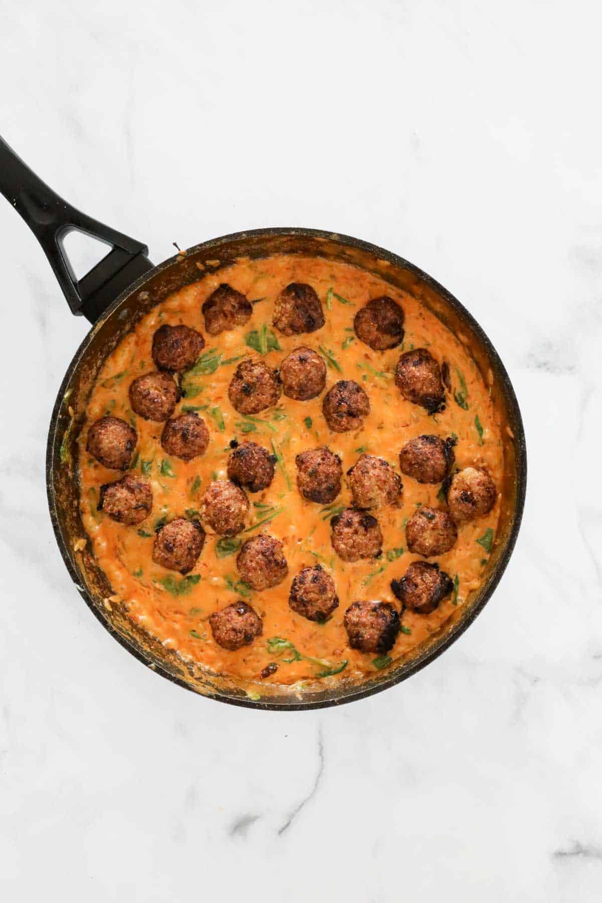 The baked pork meatballs added to the pan of creamy tomato risoni.
