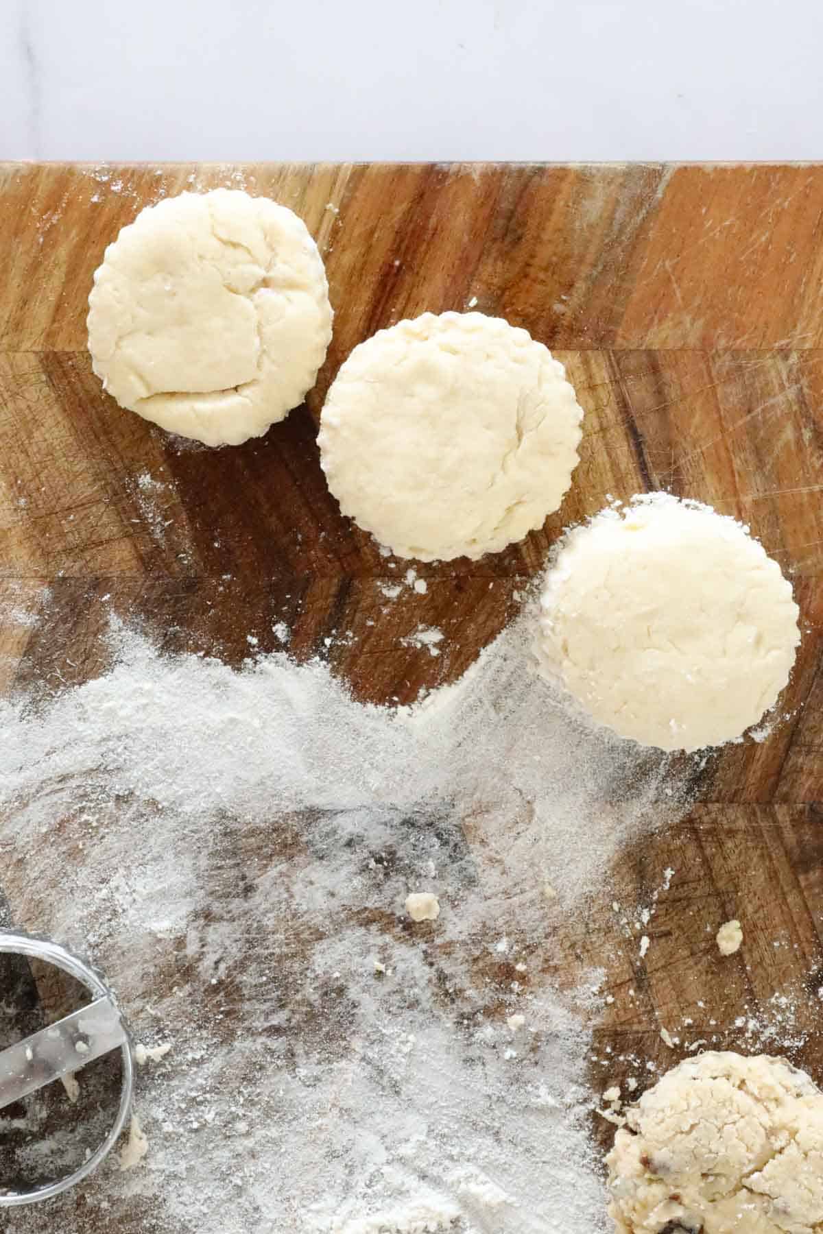 Scone dough cut out on a board.