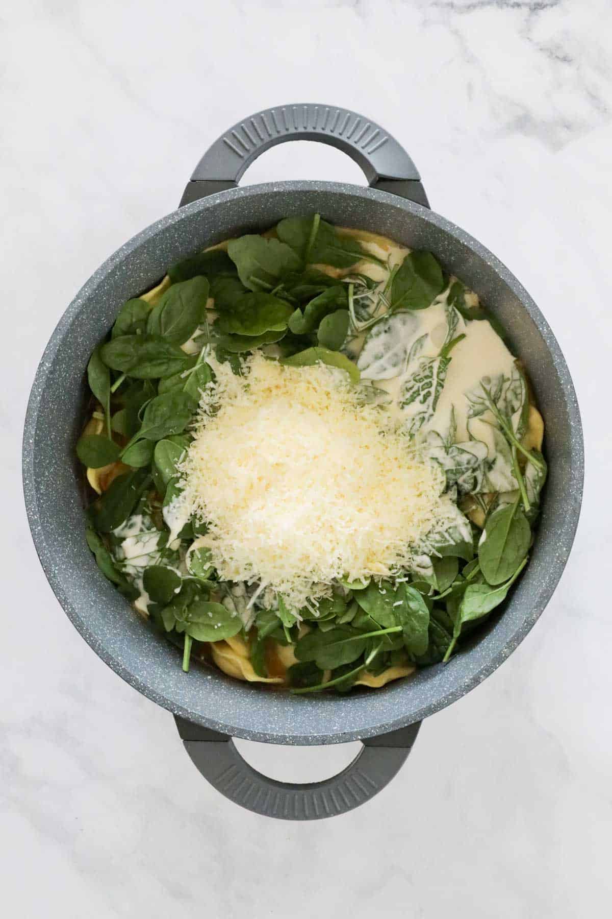 Baby spinach, cream and parmesan added to the pot.