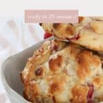 Two white chocolate and raspberry scones in a bowl.
