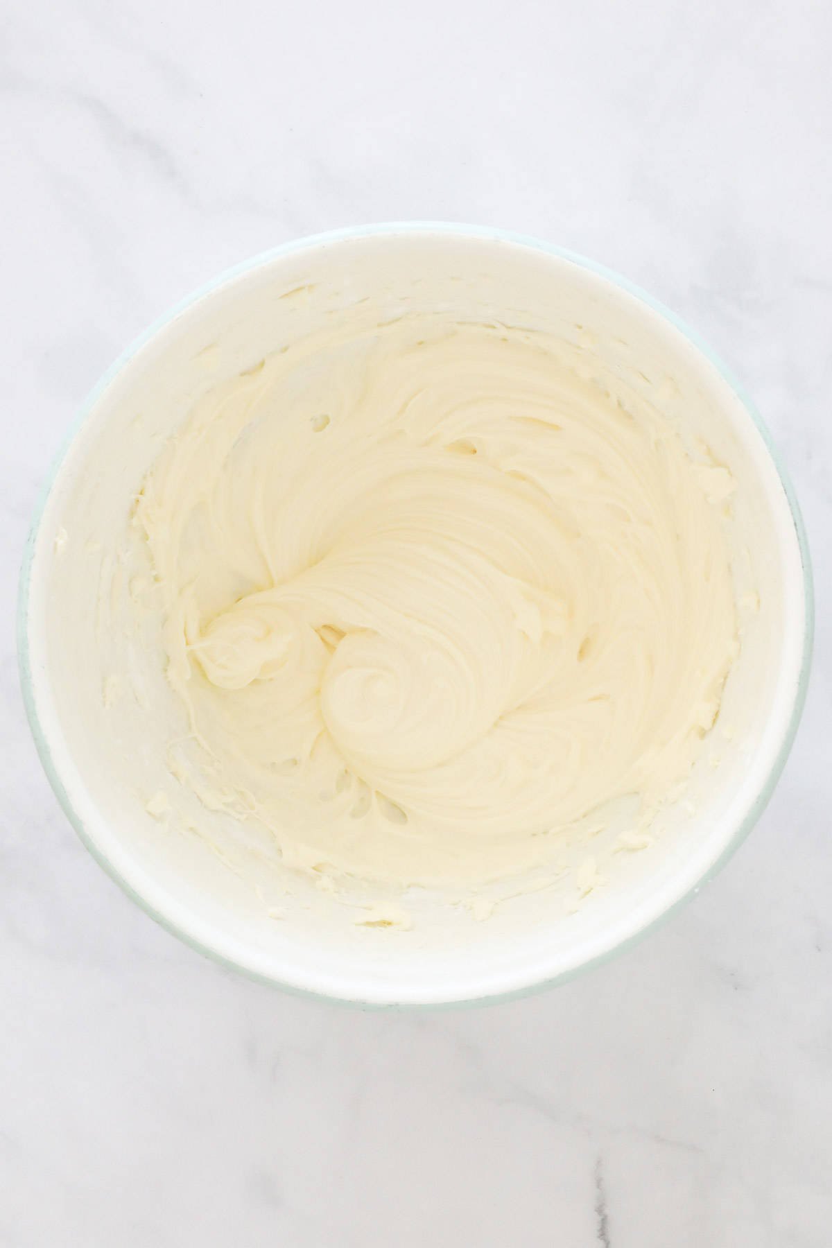 Cream cheese and icing sugar beaten together well in mixing bowl.