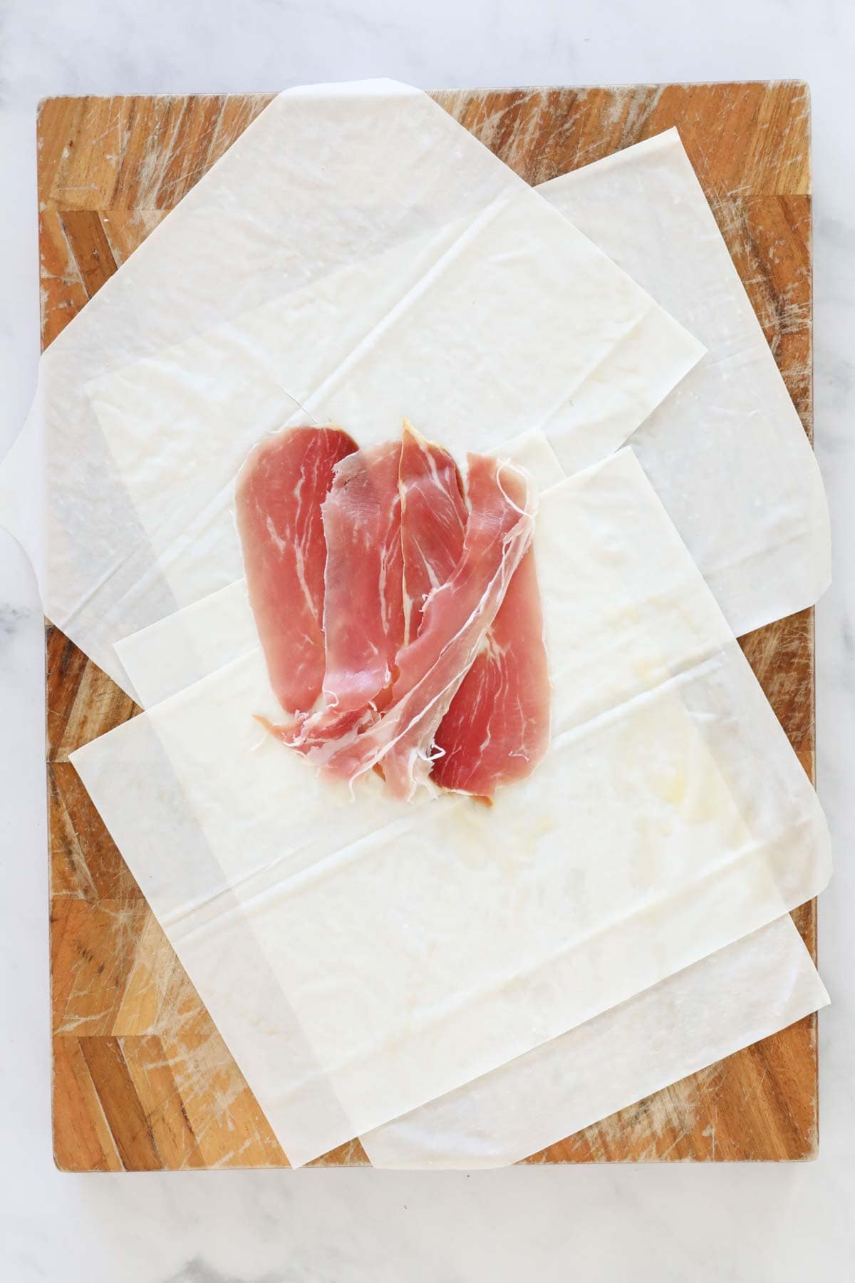 Proscuitto slices laid in the middle of the filo sheets.