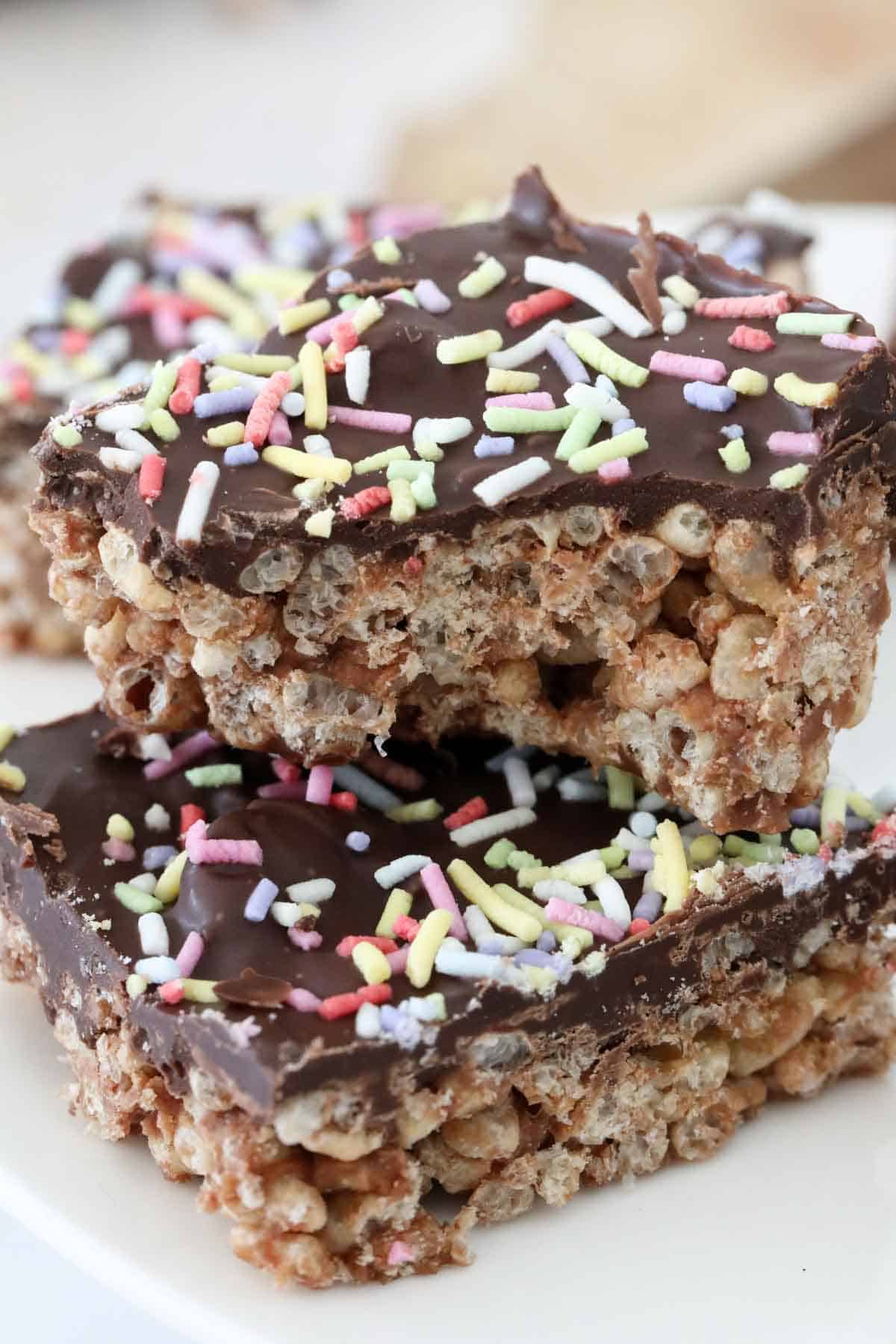 Close up side view of the slice to show the crispy rice cereal base and melted chocolate top.