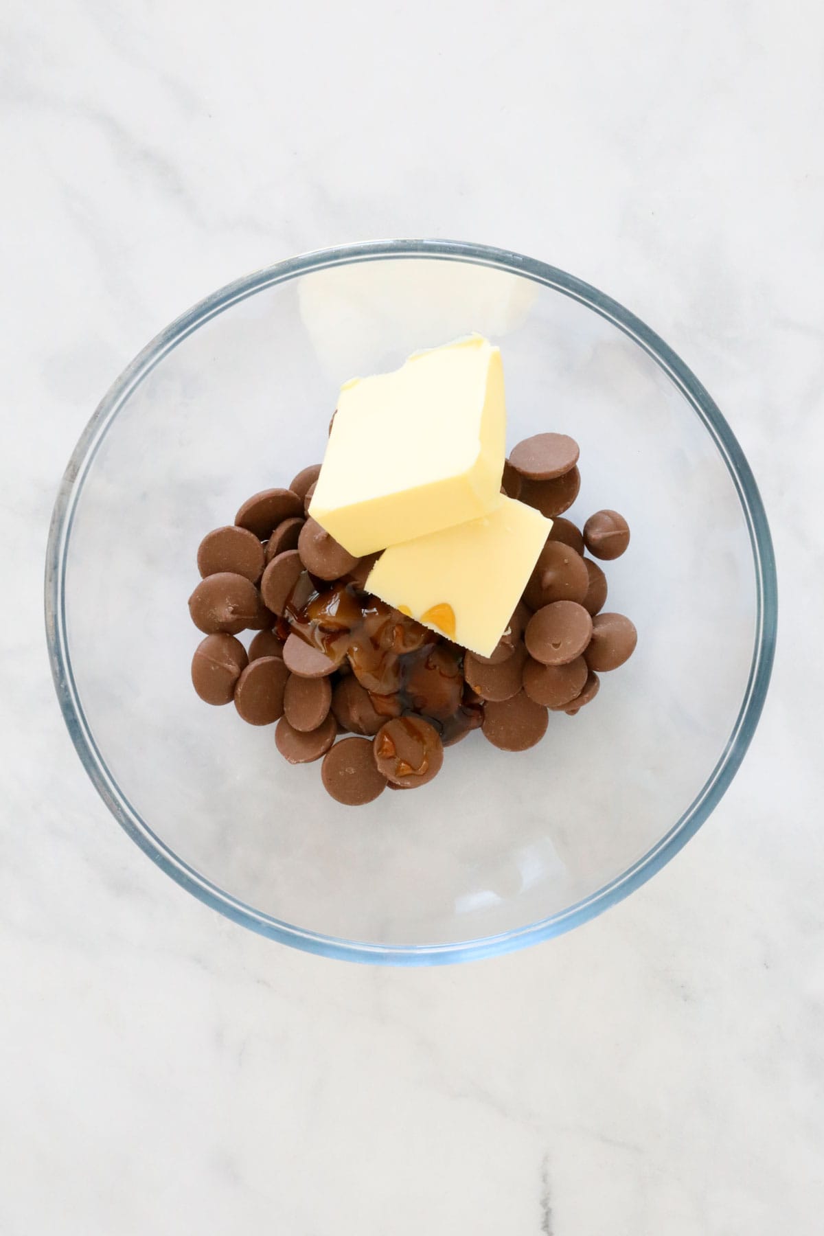 Chocolate, golden syrup and butter in a microwave safe bowl.