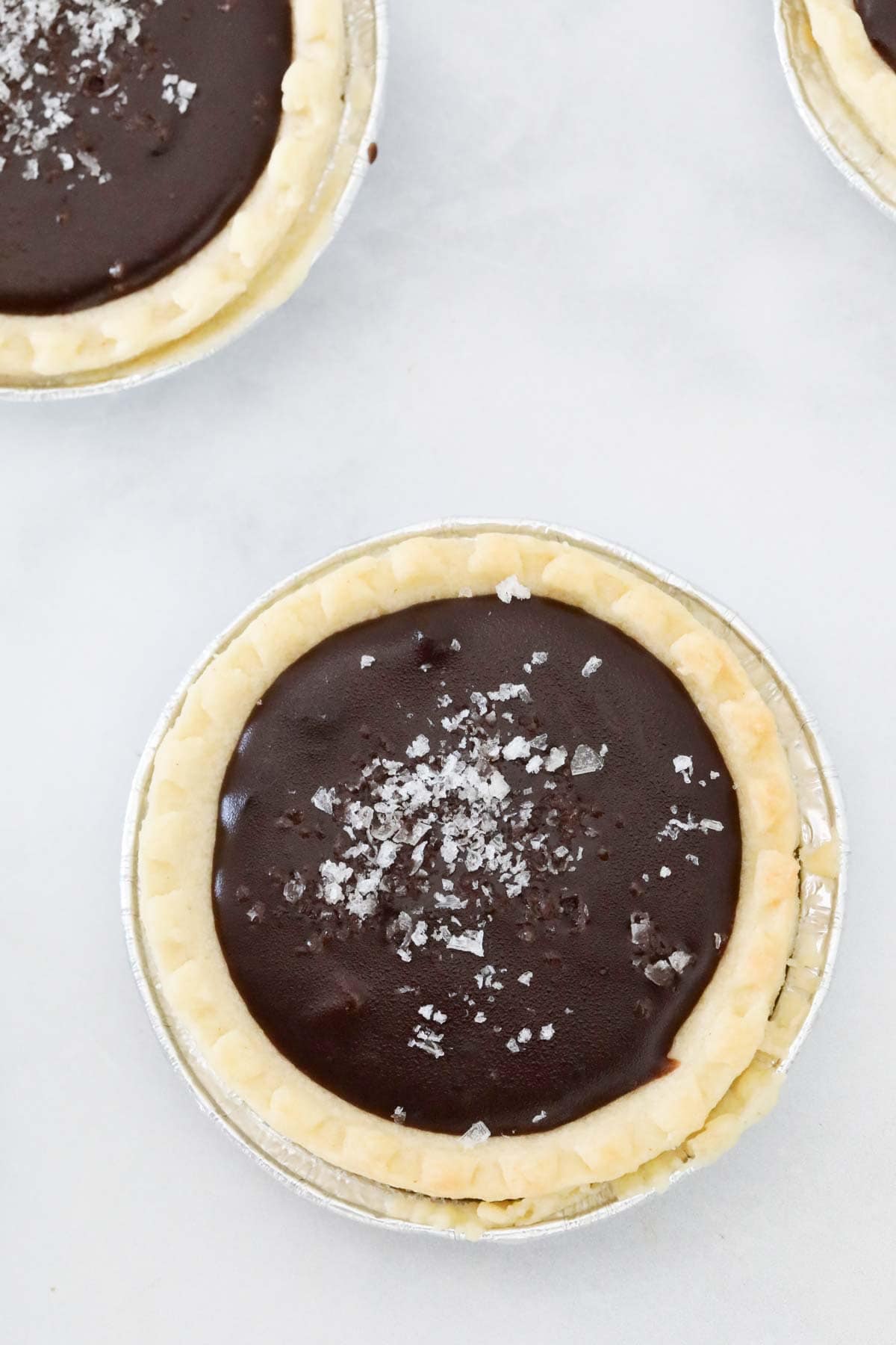 Chocolate ganache poured into a pastry case and sprinkled with salt.