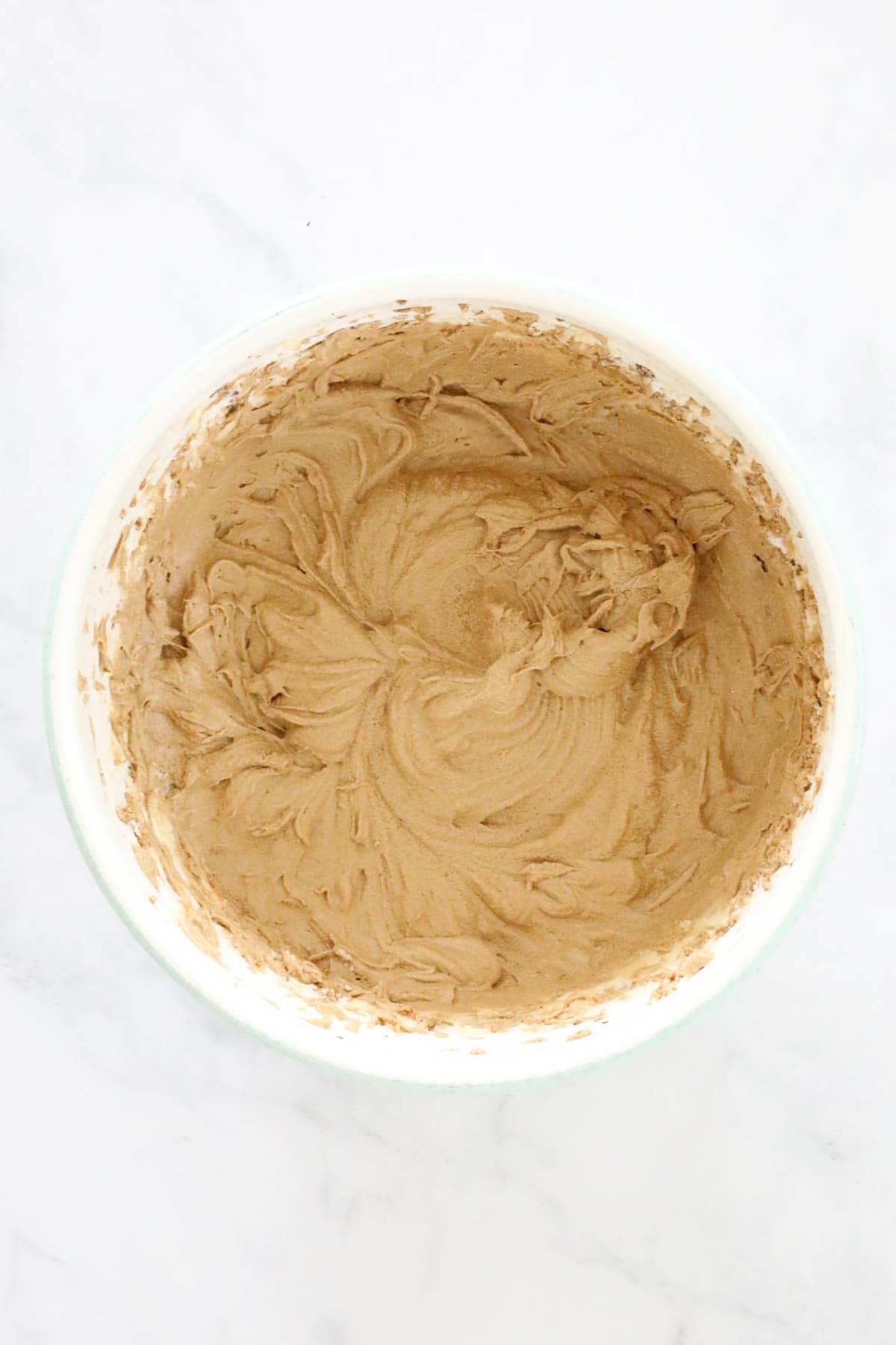 A mixing bowl with a coffee loaf mixture in it.