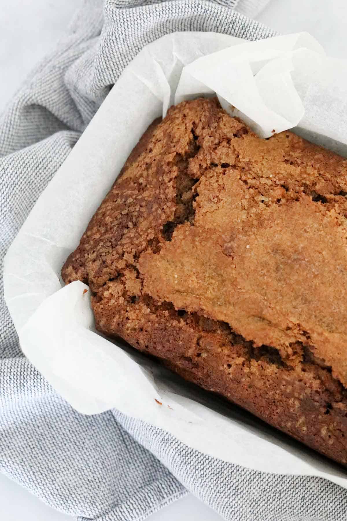 A baked loaf in a paper lined tin.