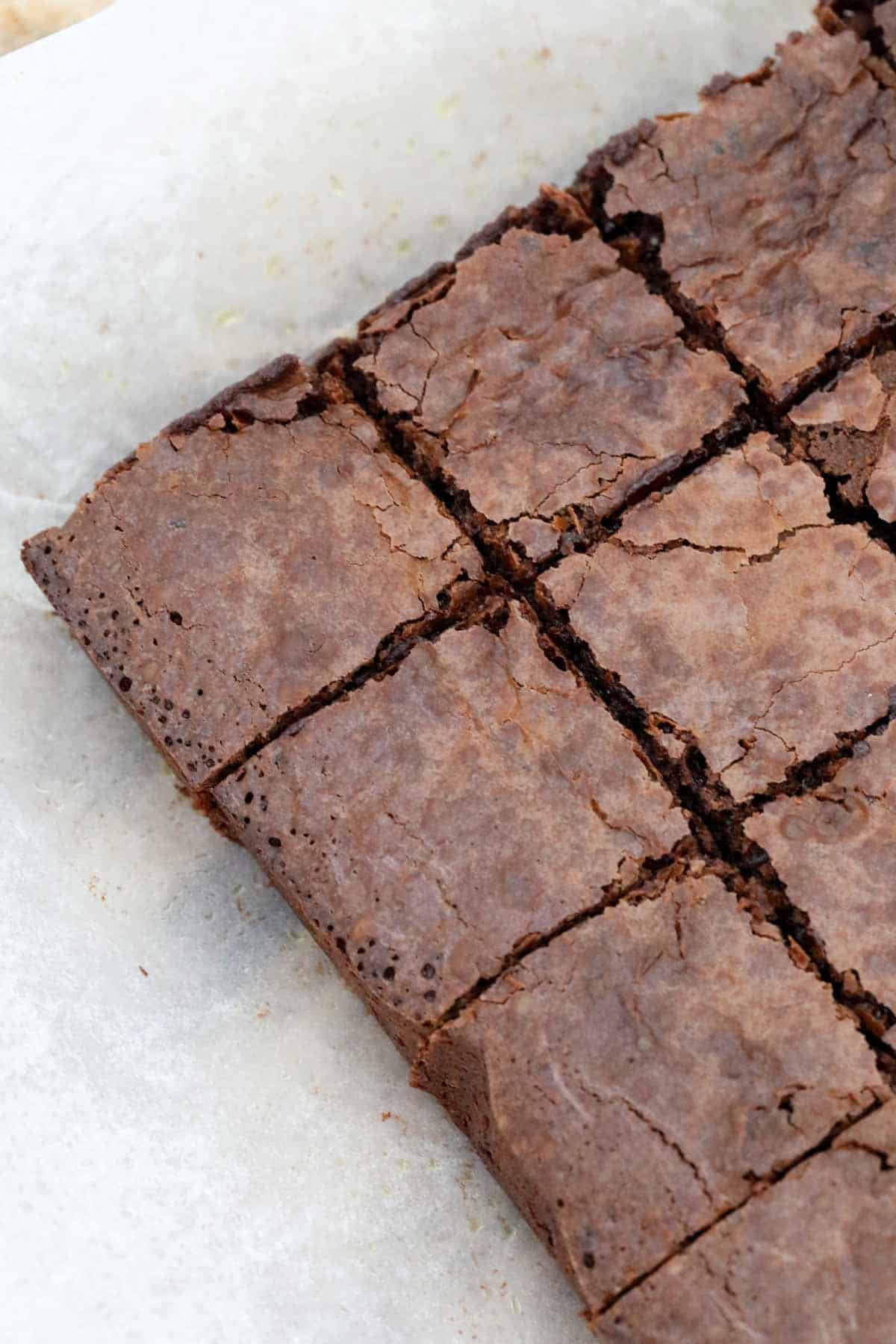 The baked espresso brownies, with flaky tops, cut into squares.