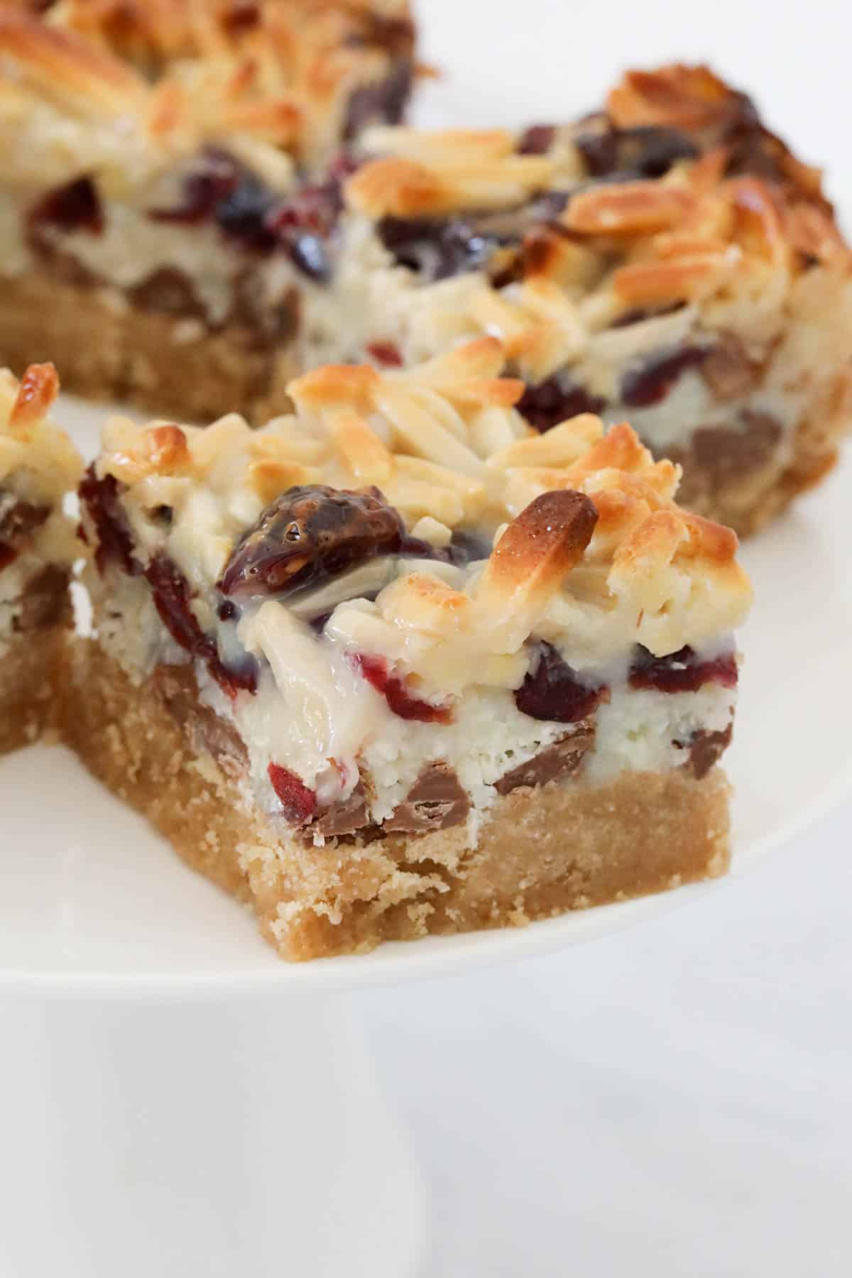 Pieces of magic coconut slice on a plate.