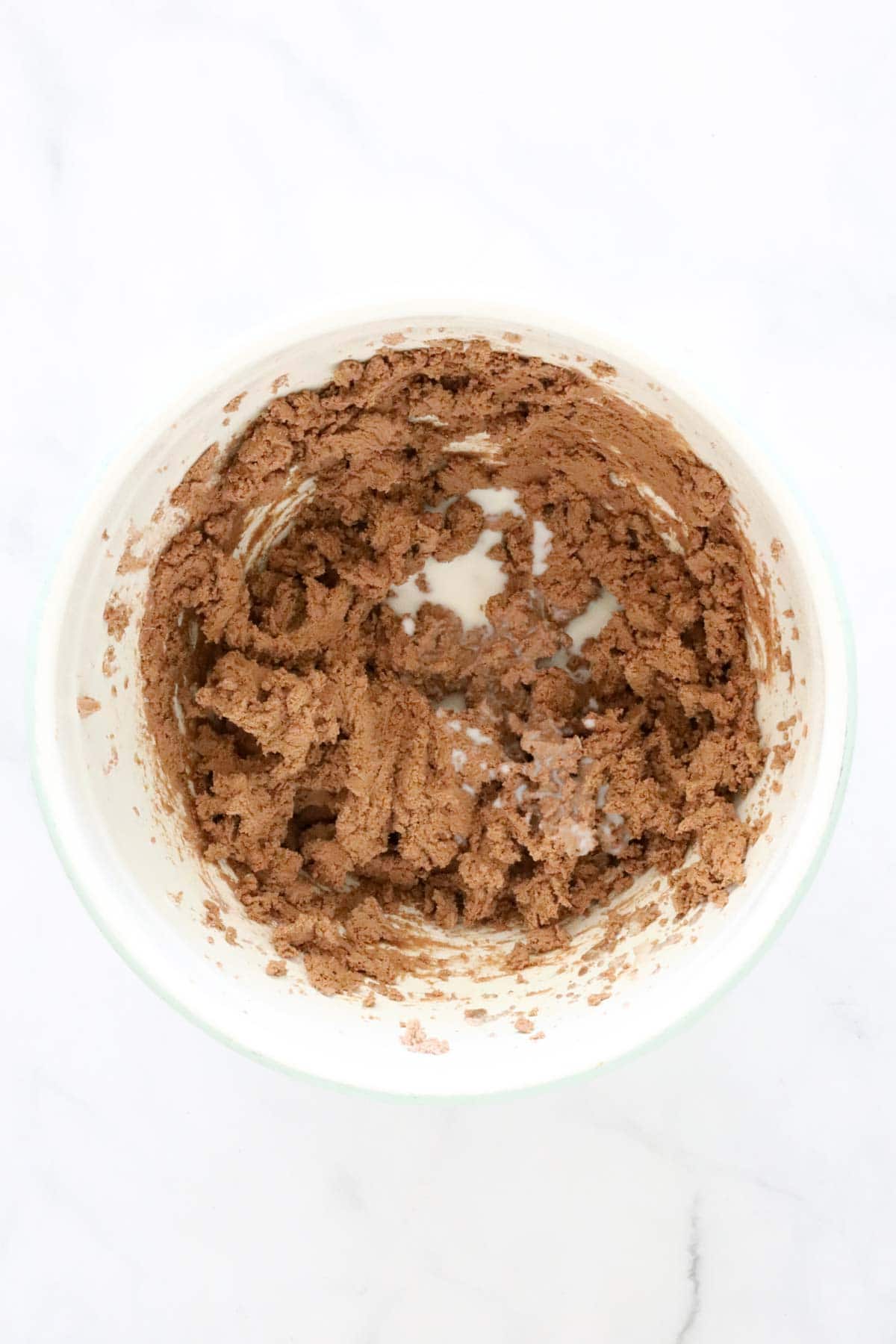 Milk added to the whisked butter cocoa mixture.