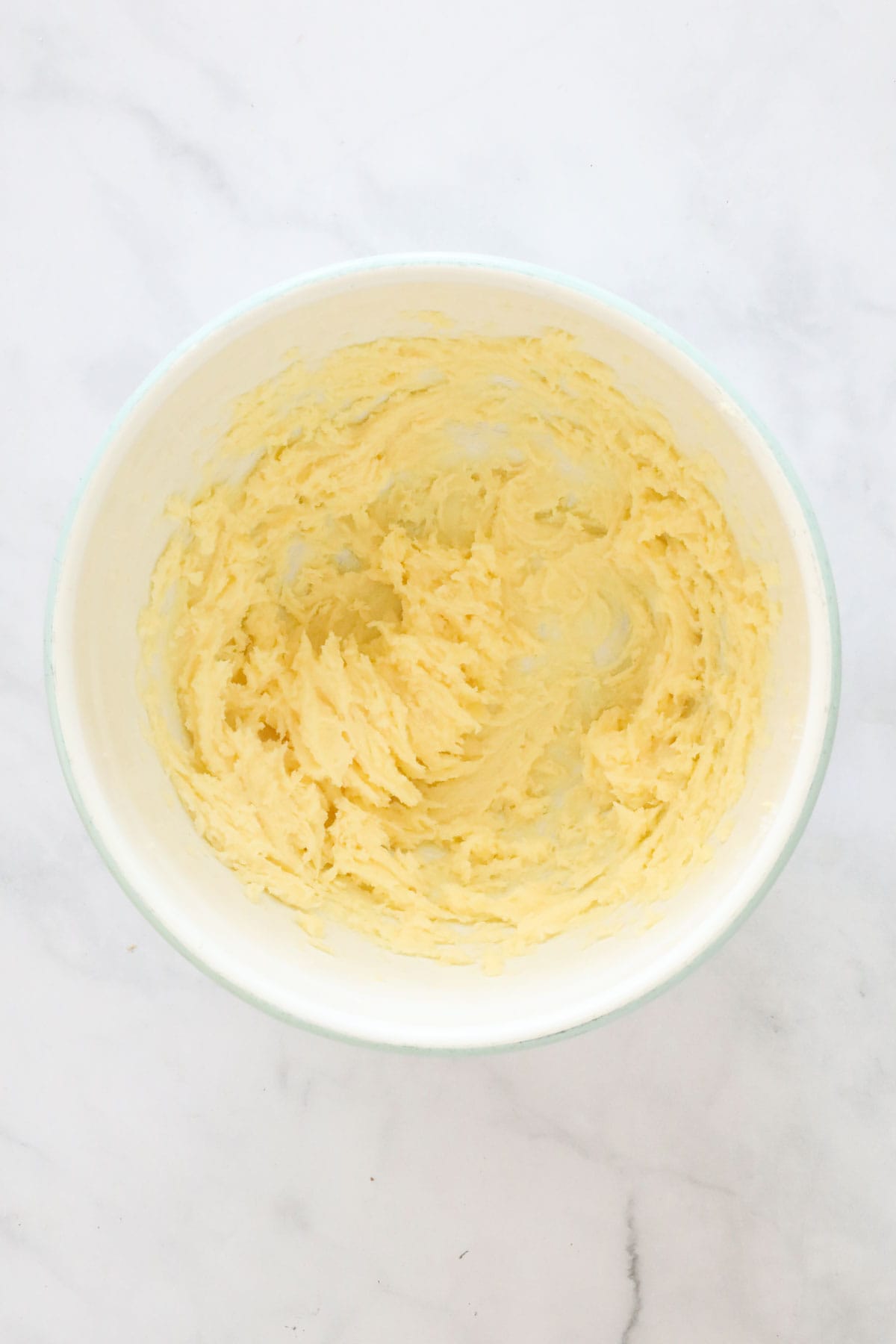 The beaten butter, sugar, salt and vanilla in a mixing bowl.