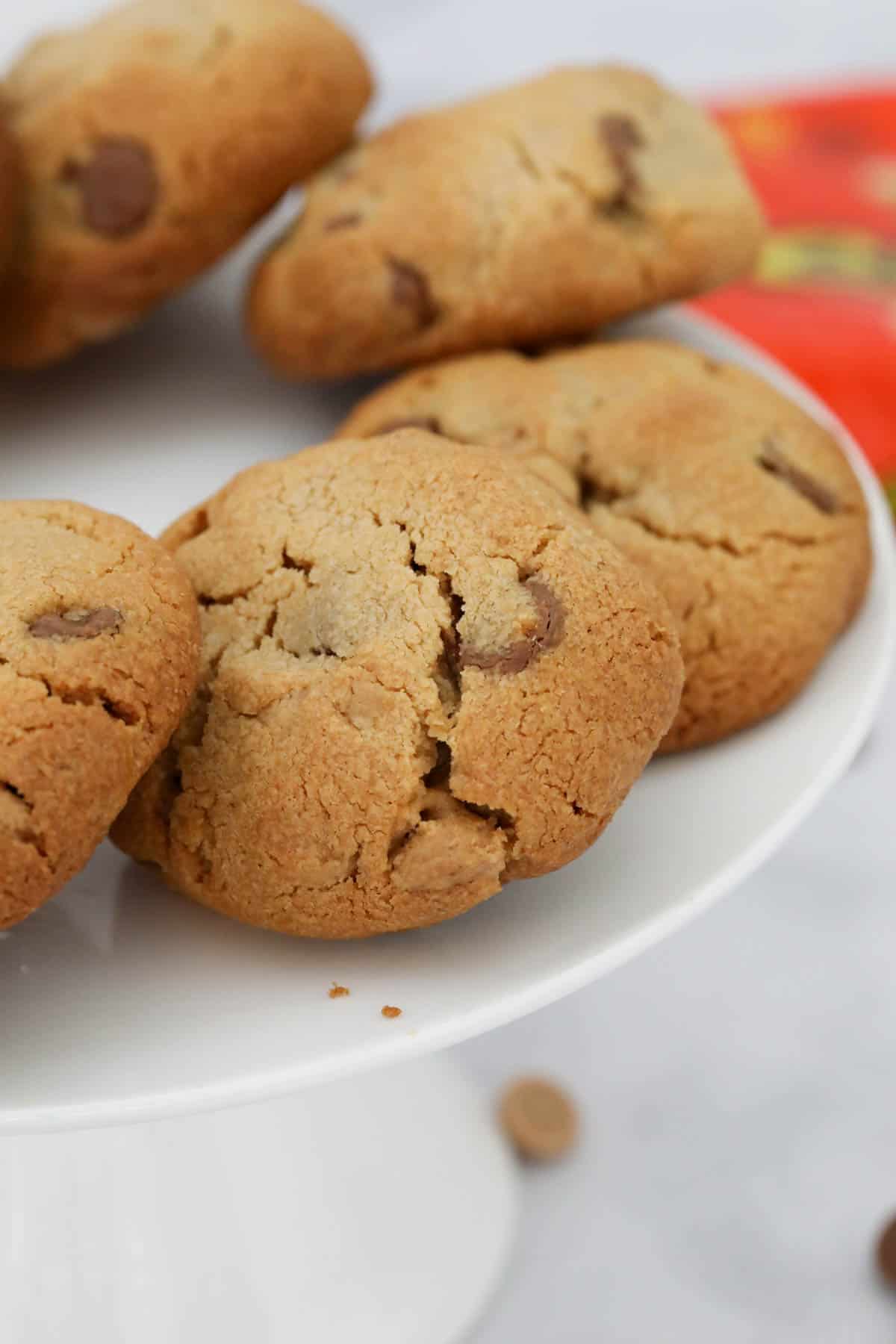 A plate of cookies, with Reeses peanut chips just visible behind.